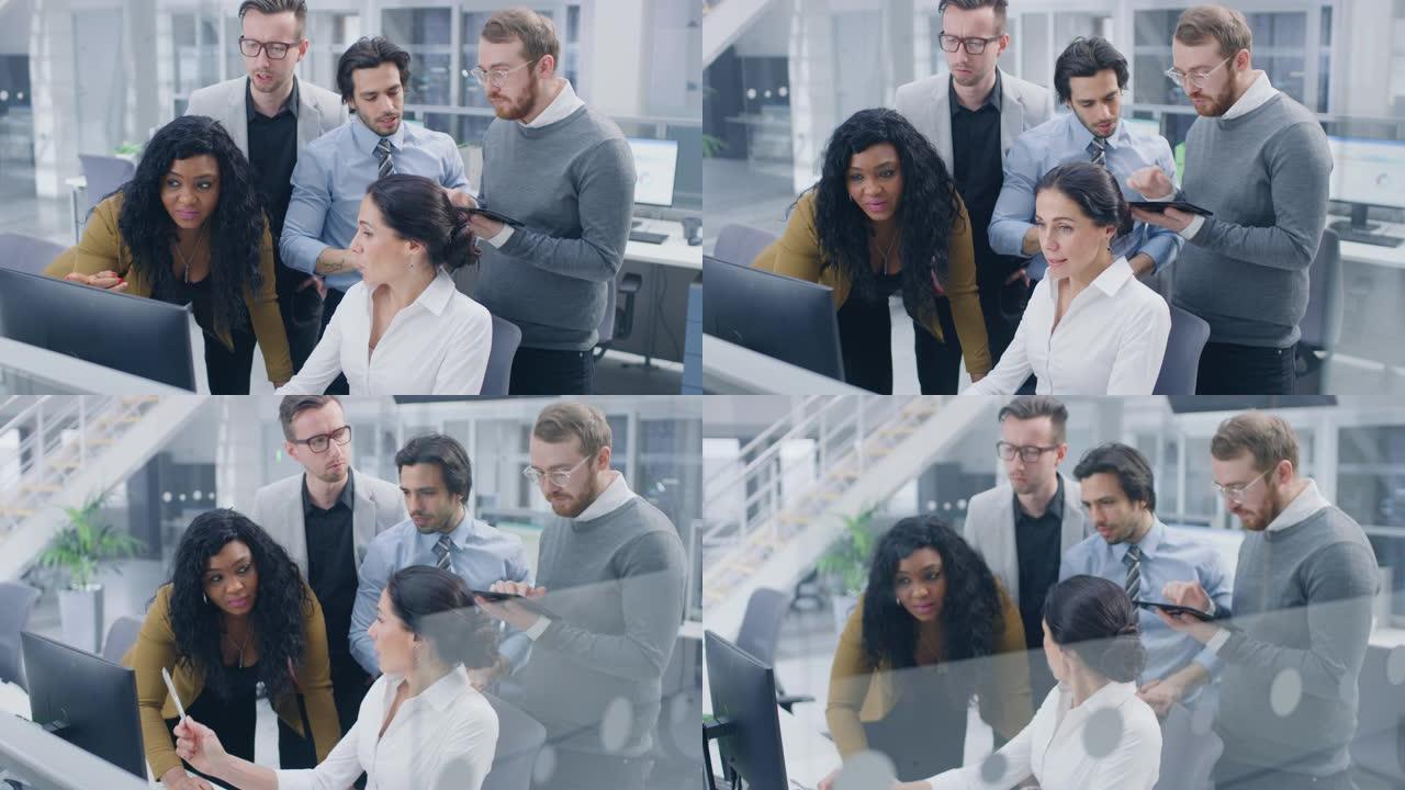 在现代办公室中: 由年轻积极进取的商人和女商人组成的多元化团队在计算机上工作，进行讨论，共同寻找问题