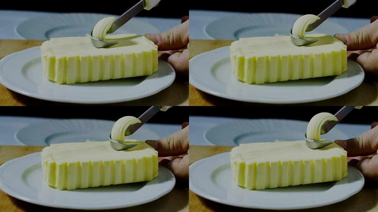 用小刀在白盘上搅打黄油的超慢动作微距 (特写)