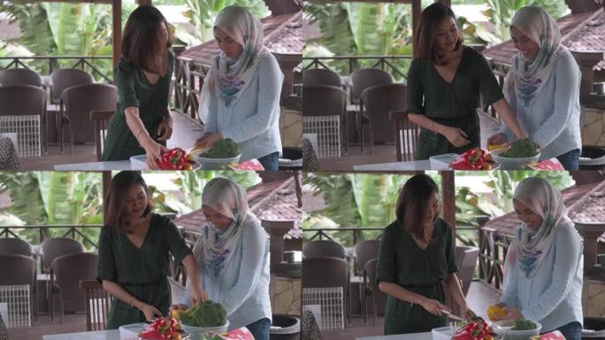 2马来女性朋友为游园会聚会准备食物