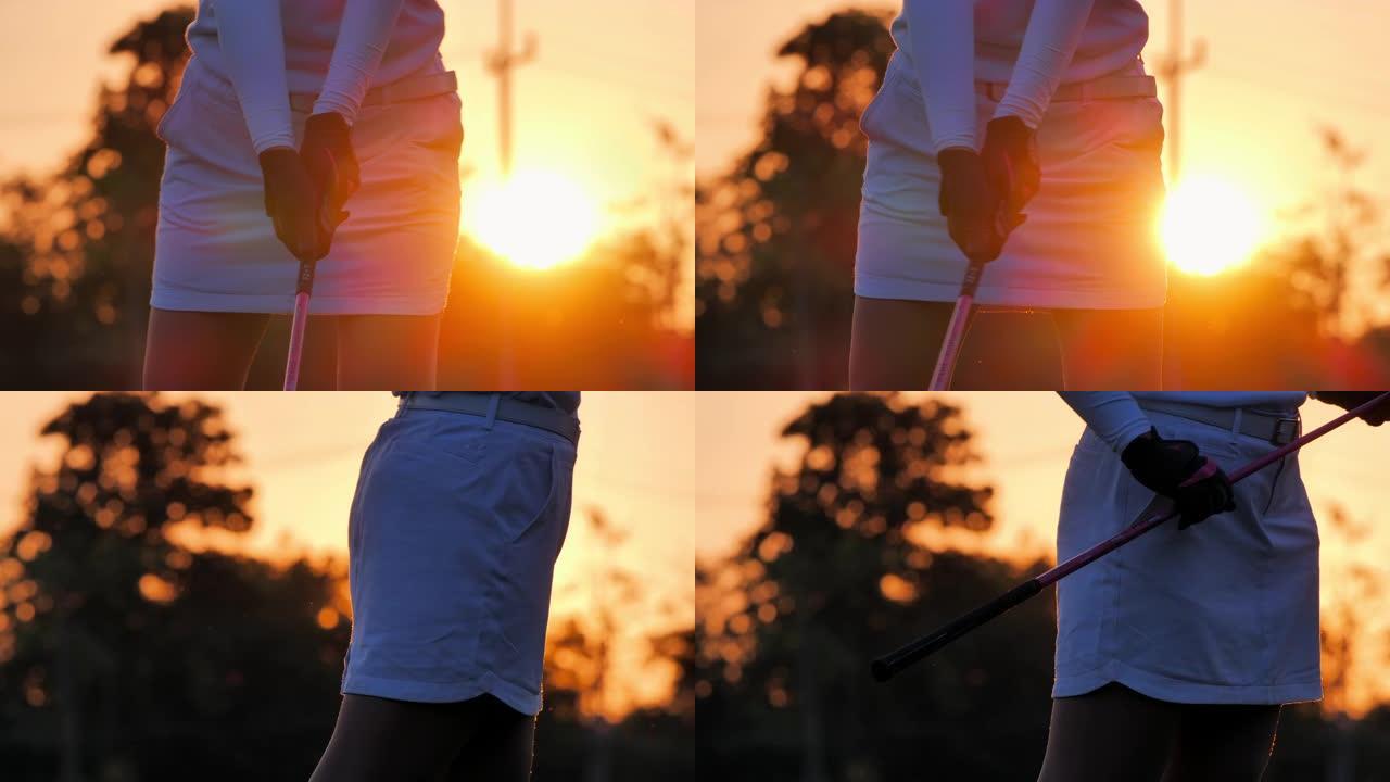 高尔夫球手的剪影妇女在夏天扫荡并保持高尔夫球场以放松身心。日落时的剪影高尔夫球手。体育电影。自信，力