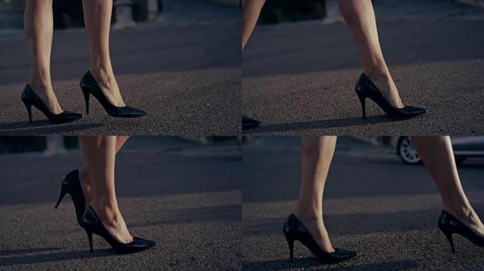 穿着高跟鞋在城市里散步的女商人。腿部特写