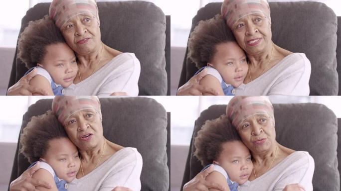 患有癌症的高级妇女亲切地抱着孙女