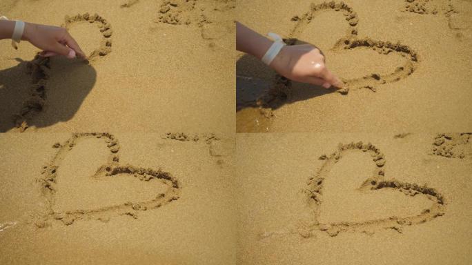 女孩在沙滩上画心脏符号。