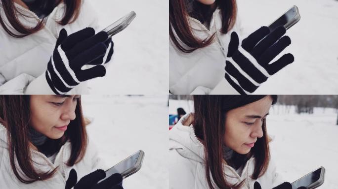 亚洲游客在北海道通过电话拍摄雪山的照片。