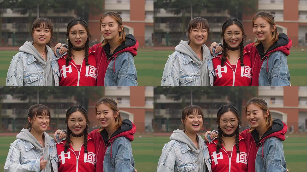 三个快乐的亚洲女大学生对着镜头微笑