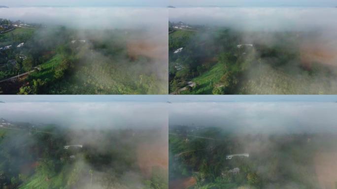 俯瞰云层的山顶村庄的鸟瞰图，4K DCI