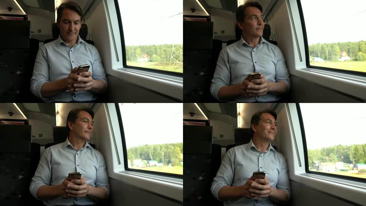 英俊的男人在火车上通勤，用智能手机发短信，然后看着风景