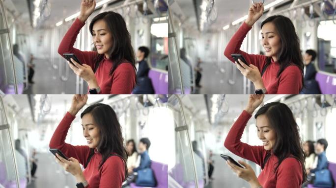 在地铁中使用智能手机的亚洲女性