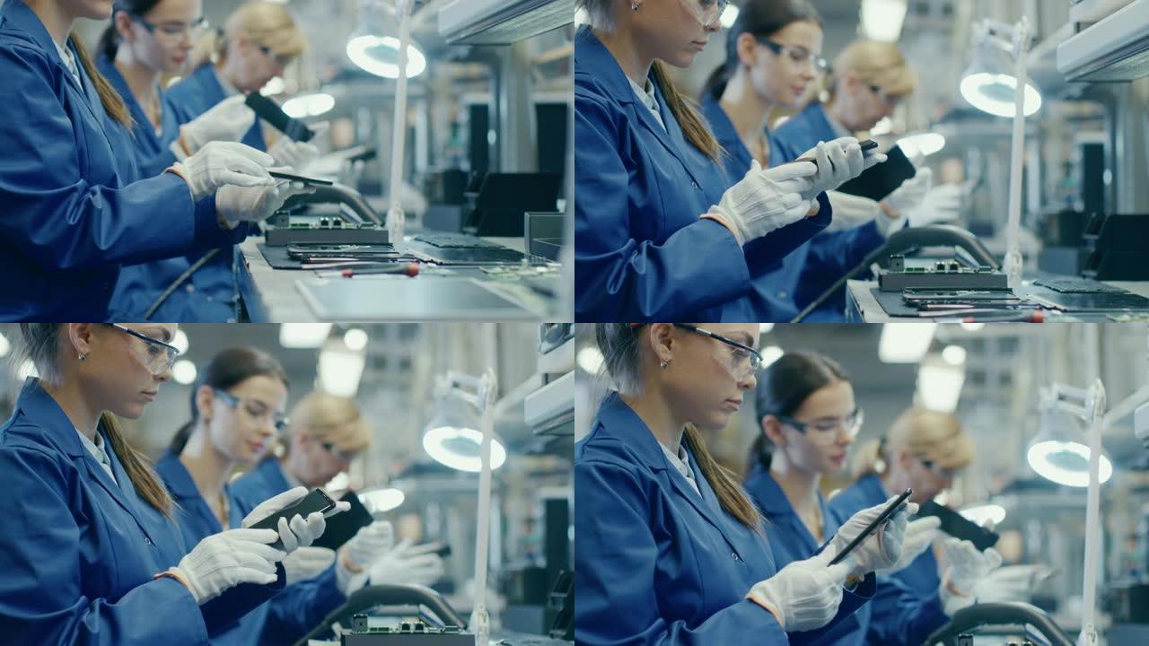 穿着蓝色工作服和防护眼镜的女电子工厂工人拿起智能手机屏幕并进行质量检查。拥有多名员工的高科技工厂设施