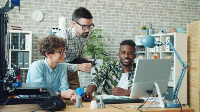 一群在办公室工作的人使用3d打印机、平板电脑和电脑聊天
