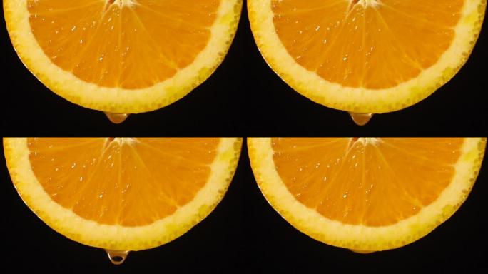 慢动作: 从橙色切片上滴一滴水