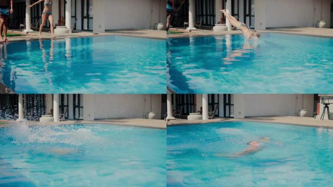 美丽的金发女孩和英俊的运动男孩一头扎进游泳池。有吸引力的年轻人跳入室外游泳池的蓝色水中降温。美丽的暑
