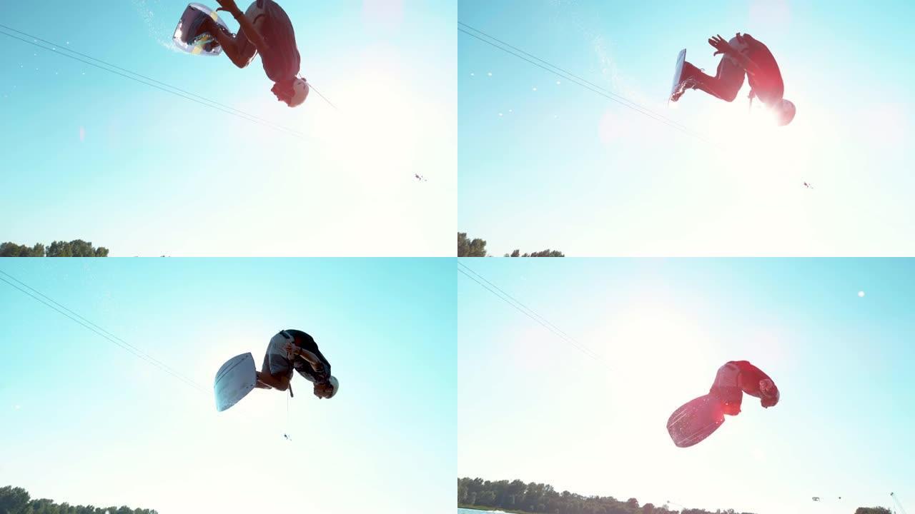 慢动作: 运动冲浪者花花公子在飞过天空时做后空翻。
