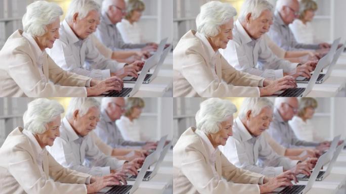 老年人在技术课上使用笔记本电脑