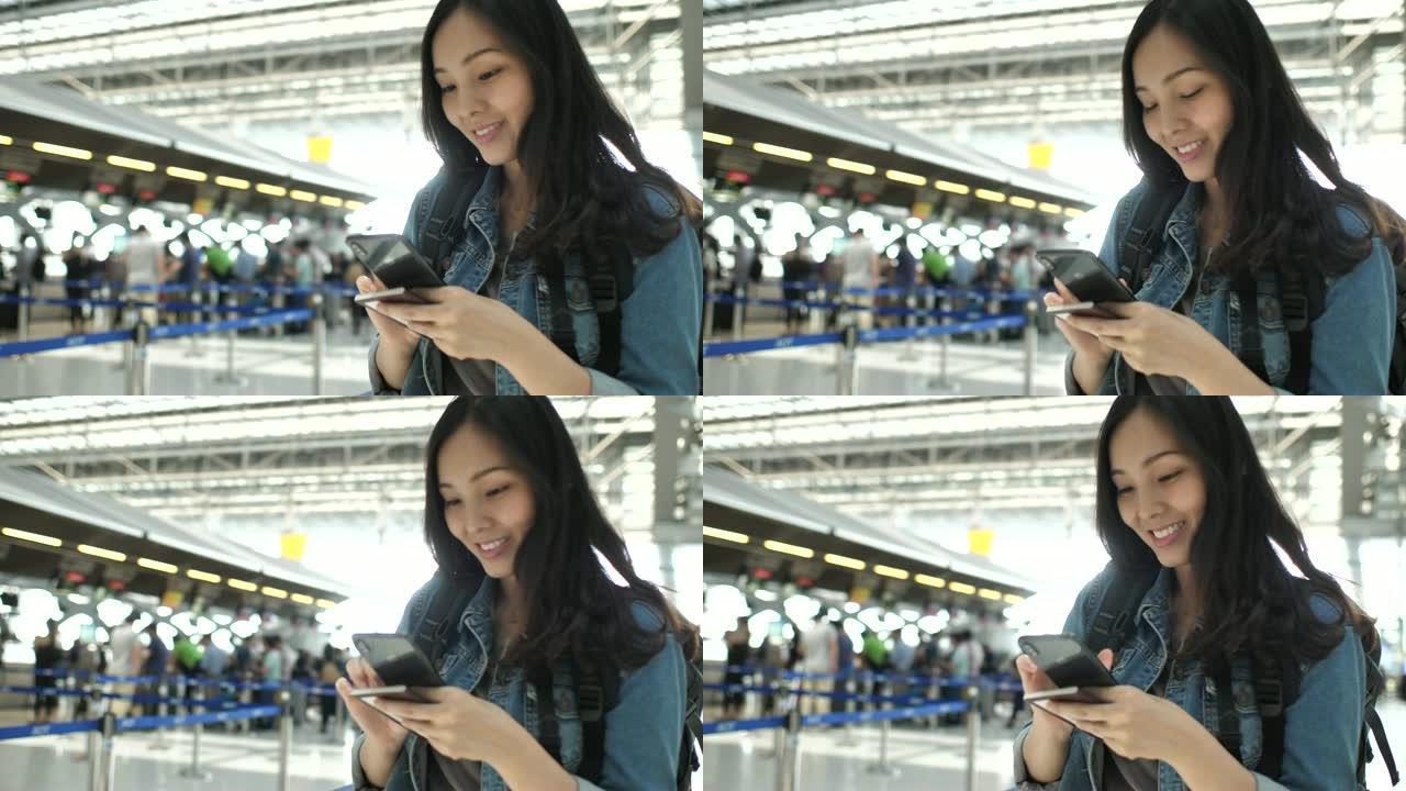 亚洲旅游妇女在机场航站楼使用电话