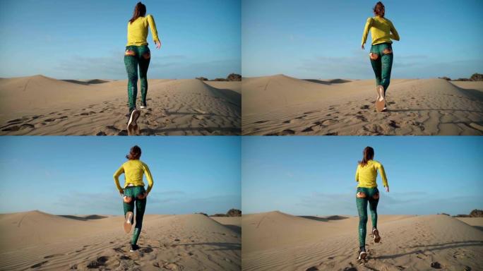 沙漠奔跑。后视图美女外国运动健身奋斗沙漠