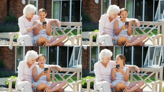 孙女在参观养老院时向祖母展示手机