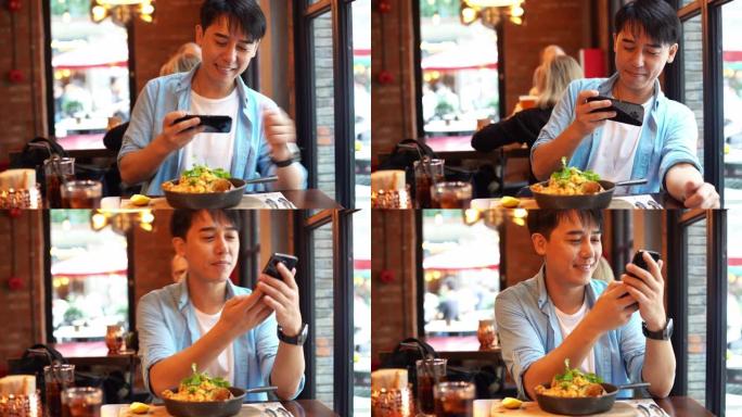 年轻的亚洲男子用智能手机拍摄食物照片
