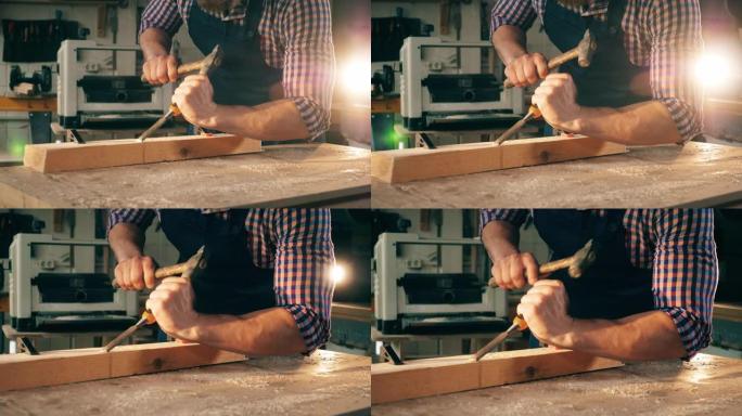 男性木匠在使用木材时使用工具。