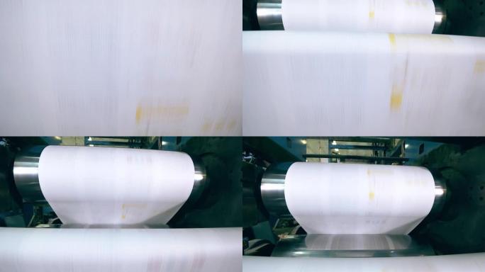 印刷纸沿着工厂机器的卷轴运行