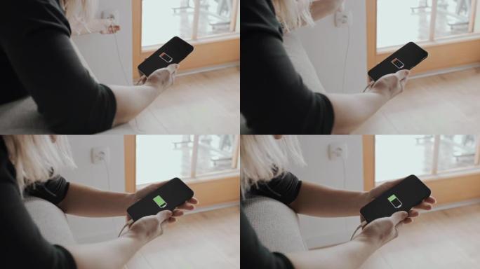 DS女人在插入墙壁电源插座的充电器上连接智能手机