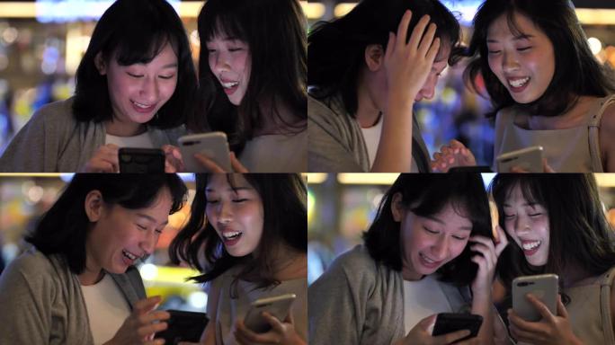 女性朋友在智能手机上分享快乐