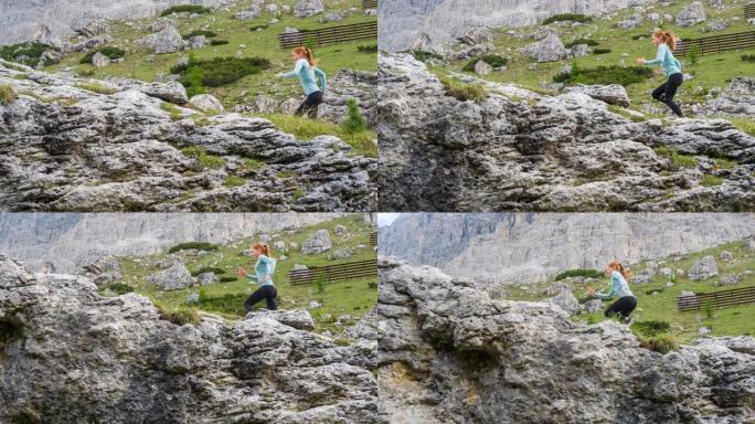 年轻健康的运动女子从陡峭的落基山上坡的人迹罕至的道路上奔跑