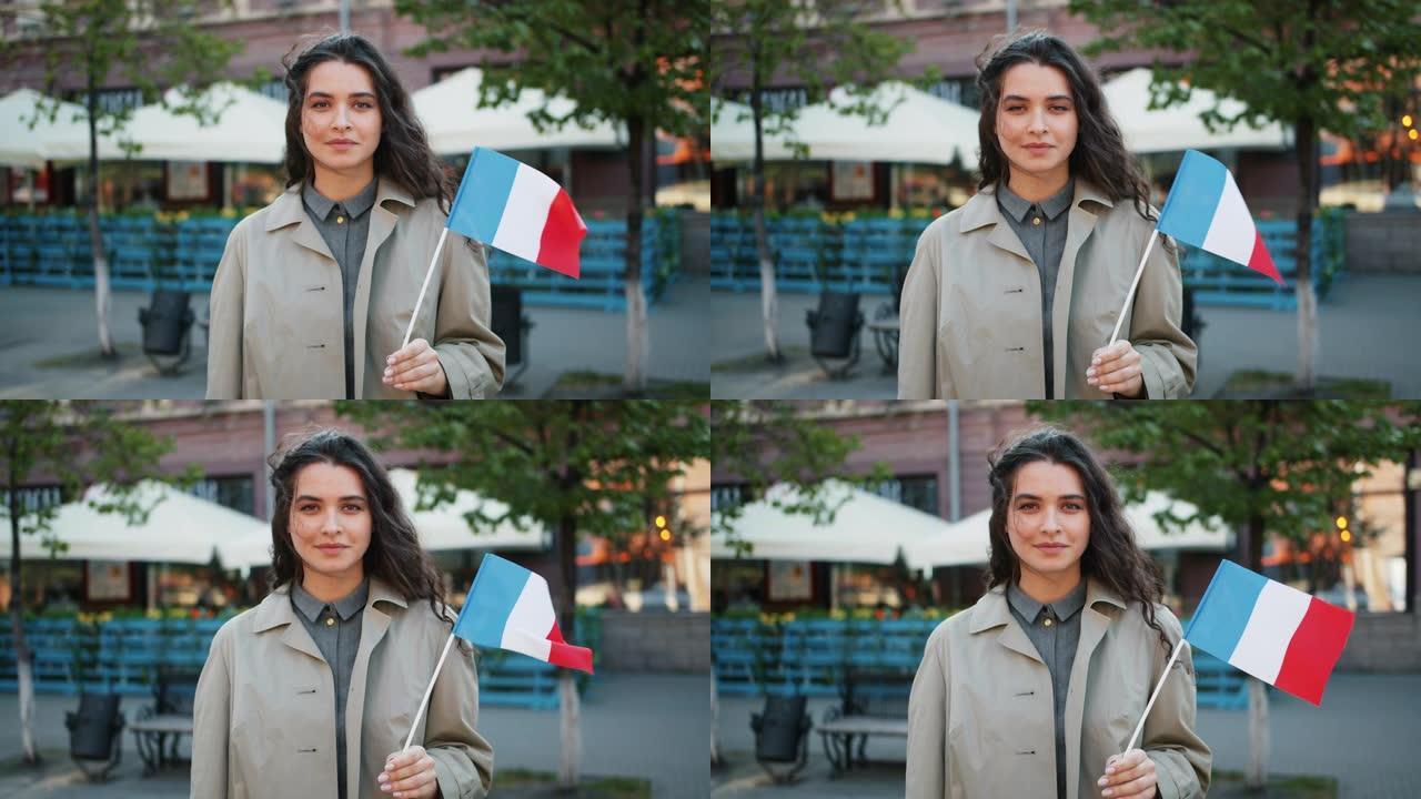 慢动作肖像可爱的法国女孩站在户外与法国国旗