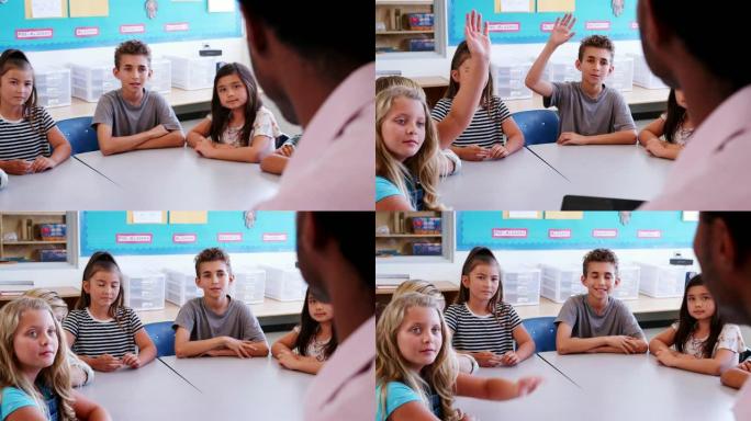 学校的孩子向拿着平板电脑的老师举手