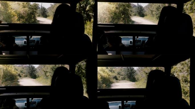 后视图年轻的旅游女子坐在safari汽车卡车的乘客沙龙中，驶入斯里兰卡的野生森林。
