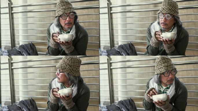 无家可归的人在人行道上拿着乞讨碗。