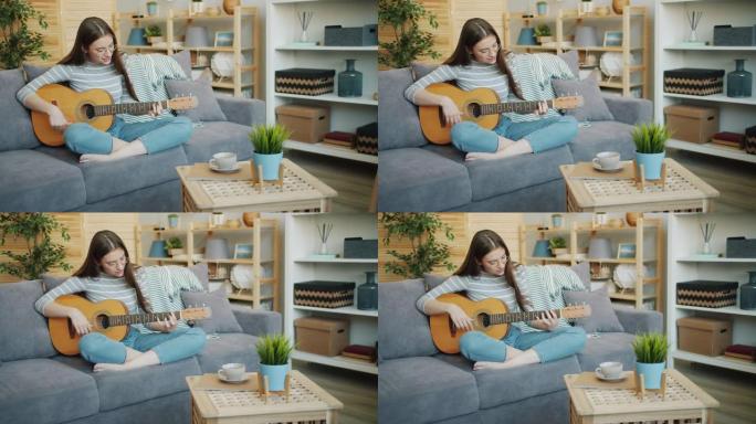美女在家弹吉他的慢动作独自玩耍