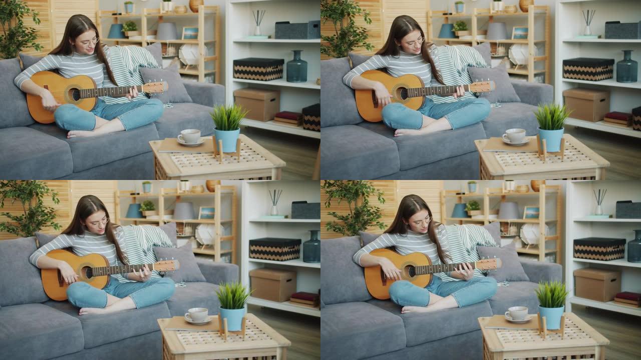 美女在家弹吉他的慢动作独自玩耍