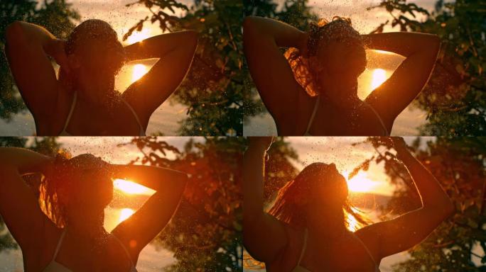 超级SLO MO女人在日落时在海滩上洗头