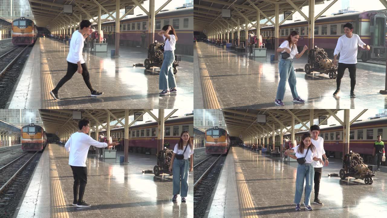 年轻夫妇在火车站一起跳舞