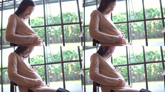 Serene pregnant woman rubing stomach