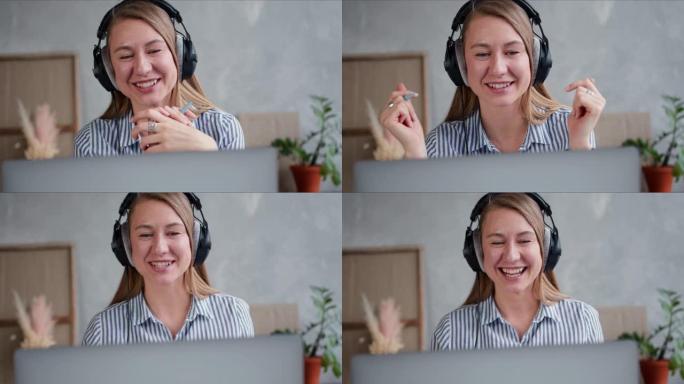 快乐的年轻积极的白人妇女在家里工作，使用笔记本电脑网络会议与朋友交谈的特写脸。