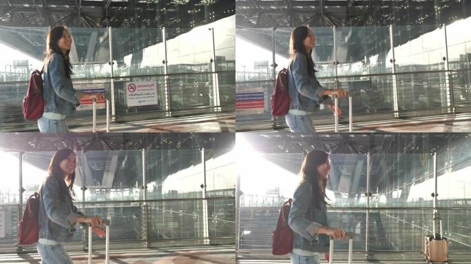 亚洲妇女在机场带着行李旅行