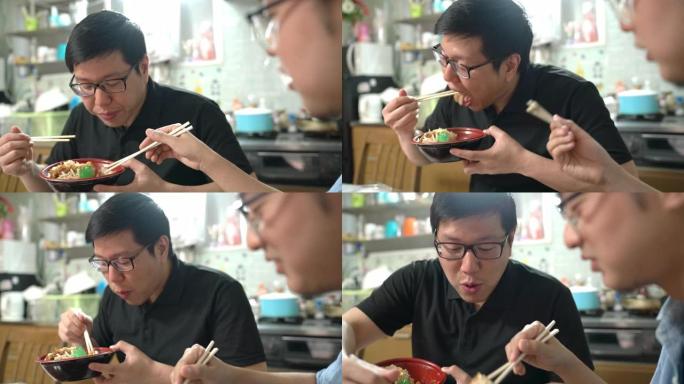 起重机拍摄了两个男人从朋友那里偷食物，吃日本食物时感觉很有趣