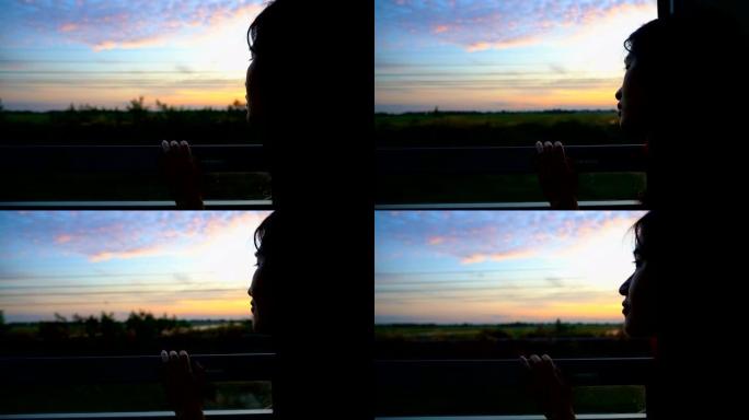 剪影女人早上从火车的窗户看美丽的天空
