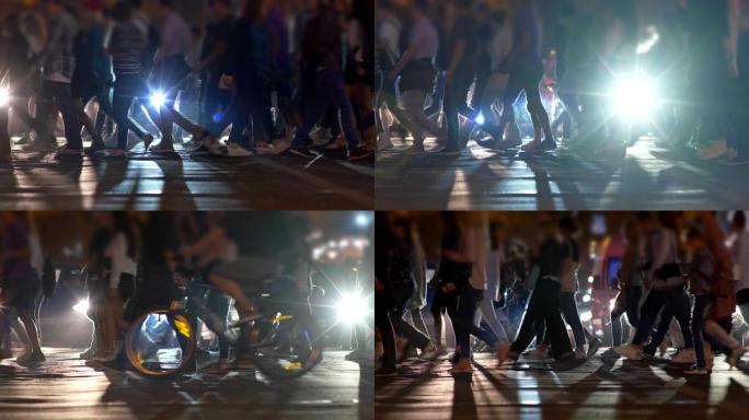 行人在人行横道上行走。晚上在城市斑马线街上面目全非的人。慢动作镜头，4K