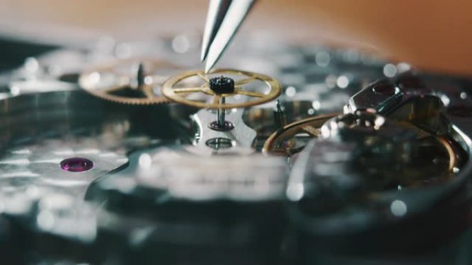 慢动作微距关闭一个专业的钟表制造商修理工在一个车间里工作的豪华机构手表齿轮。