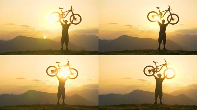 慢动作: 年轻的男性自行车手在金色日落时将自行车放在头顶。