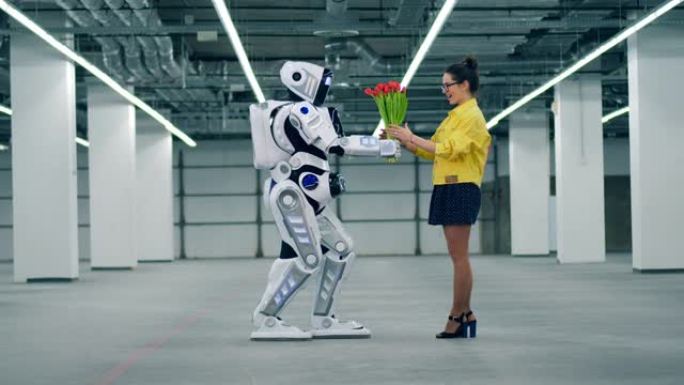 一个机器人给一个女人一束红色郁金香，她拥抱它。