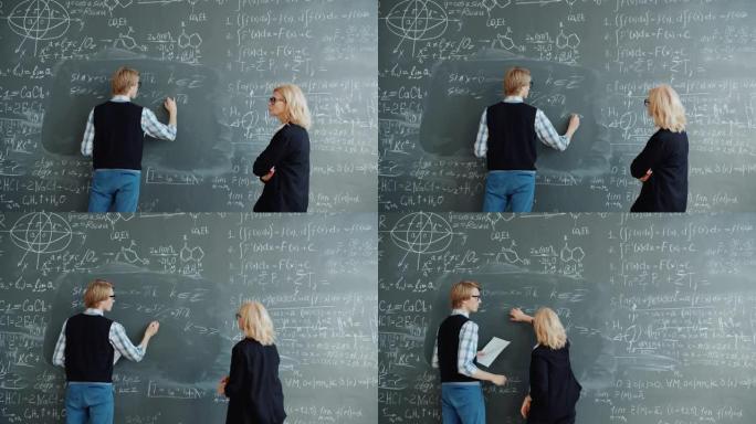 在课堂上使用黑板编写公式的学生和老师
