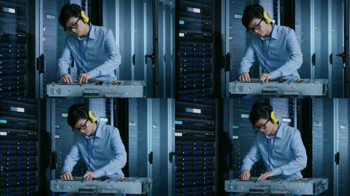 在现代数据中心: 戴着防护罩的IT工程师为服务器机架安装新硬件。IT专家负责维护，运行诊断和更新硬件
