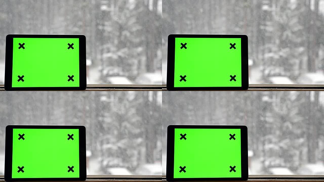 水平: 窗户下雪时间上的数字平板电脑