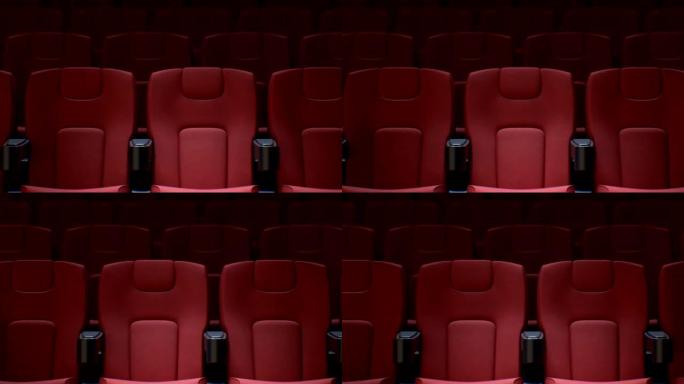 电影院大厅里的无缝红色椅子。带dop模糊的电影院中排红色座椅的循环3d动画。艺术和媒体概念。