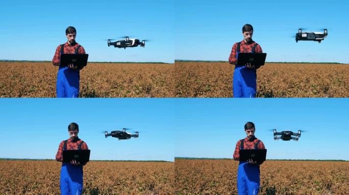 农业学家控制着田间的无人机。