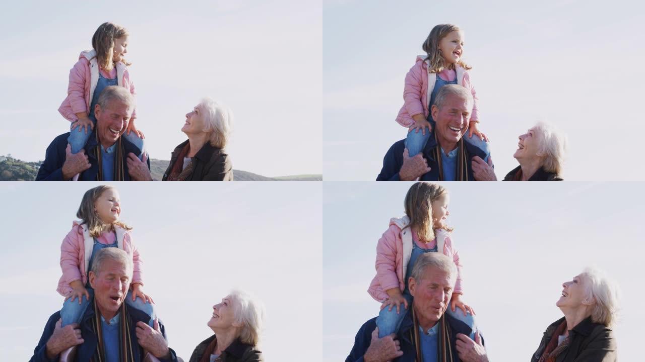 祖父让孙女与祖母一起在乡下散步时骑在肩膀上